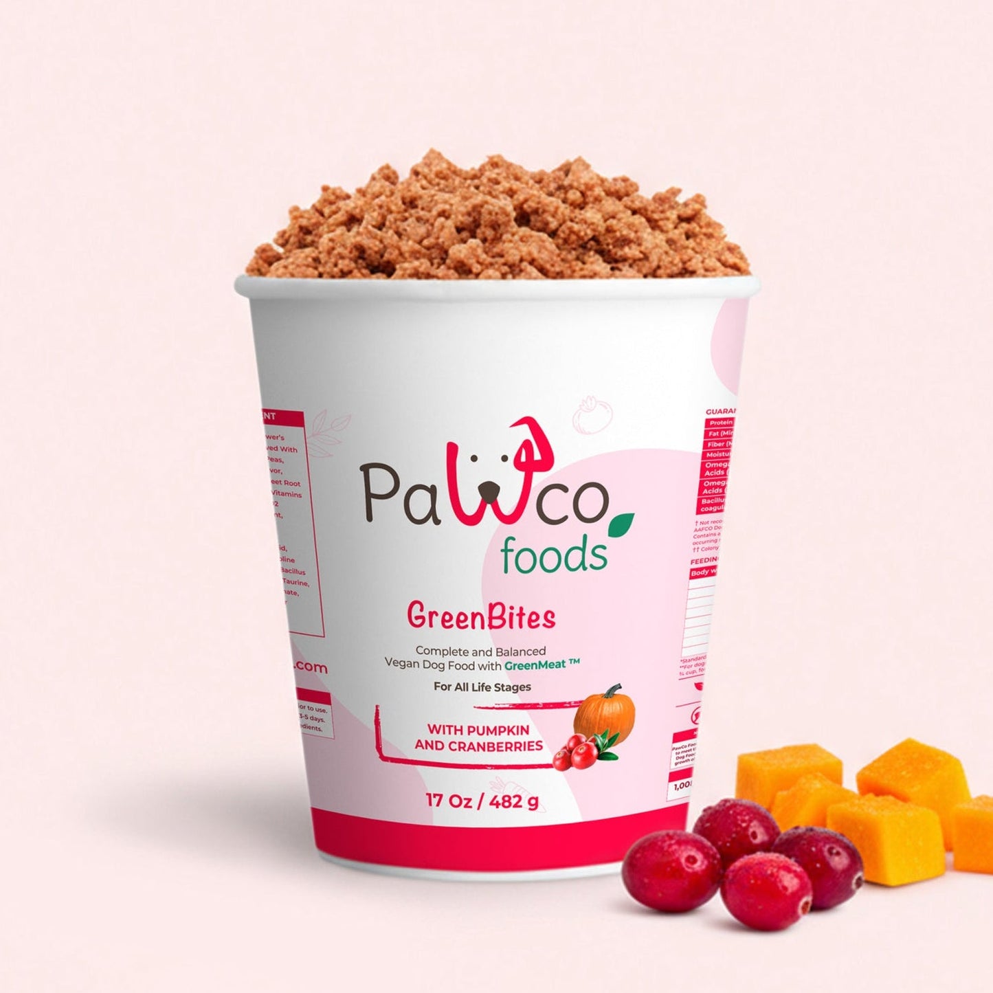 Container of Pawco Foods GreenBites with snacks on a light pink background