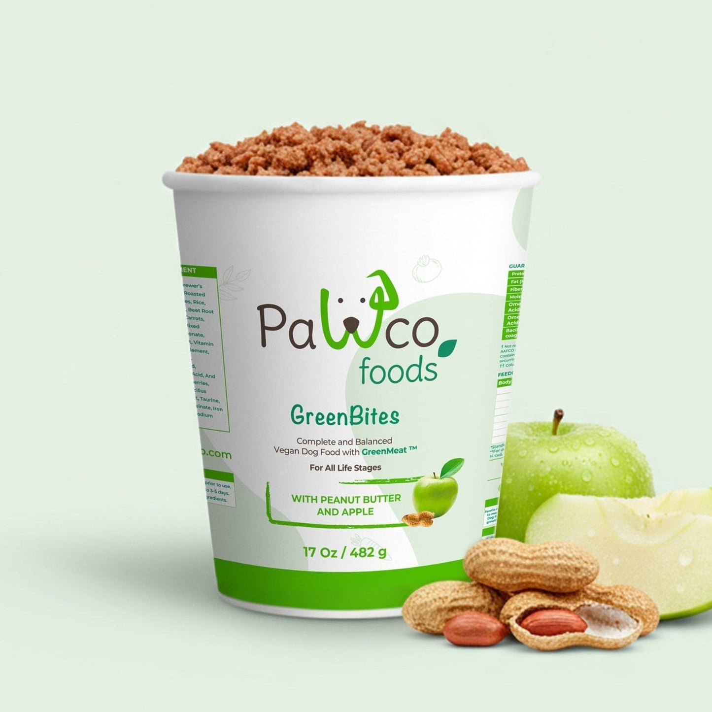 Container of Pawco Foods GreenBites with apples and almonds on a light green background